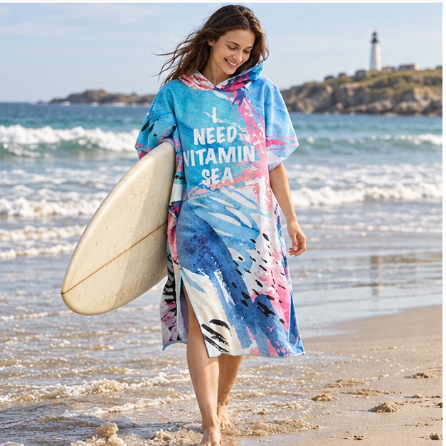 Poncho Surf Bleu Et Corail – Bleu / Adulte, porté en mouvement au bord de l’océan